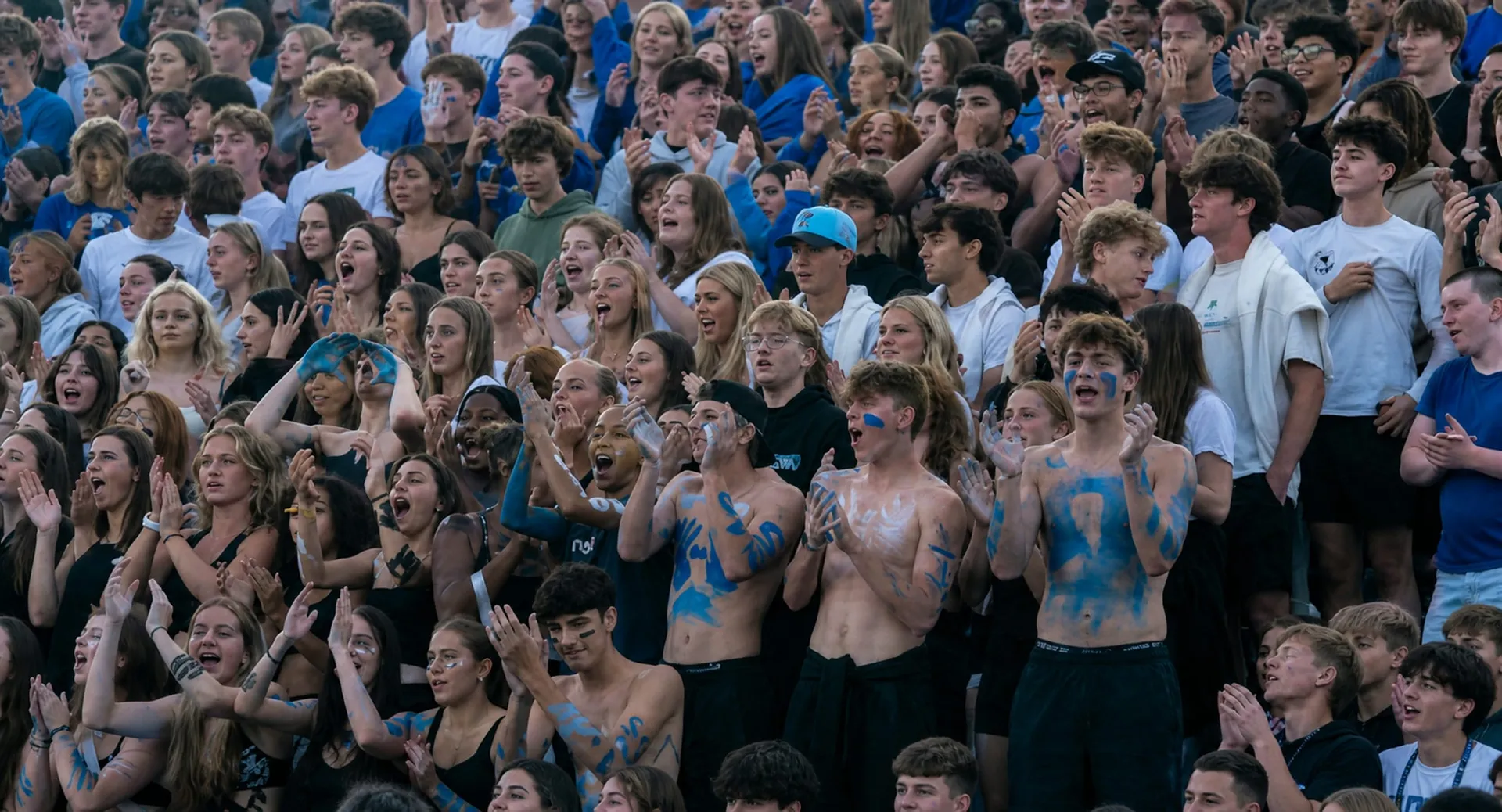 The packed Bexley student section painted up in blue and cheering