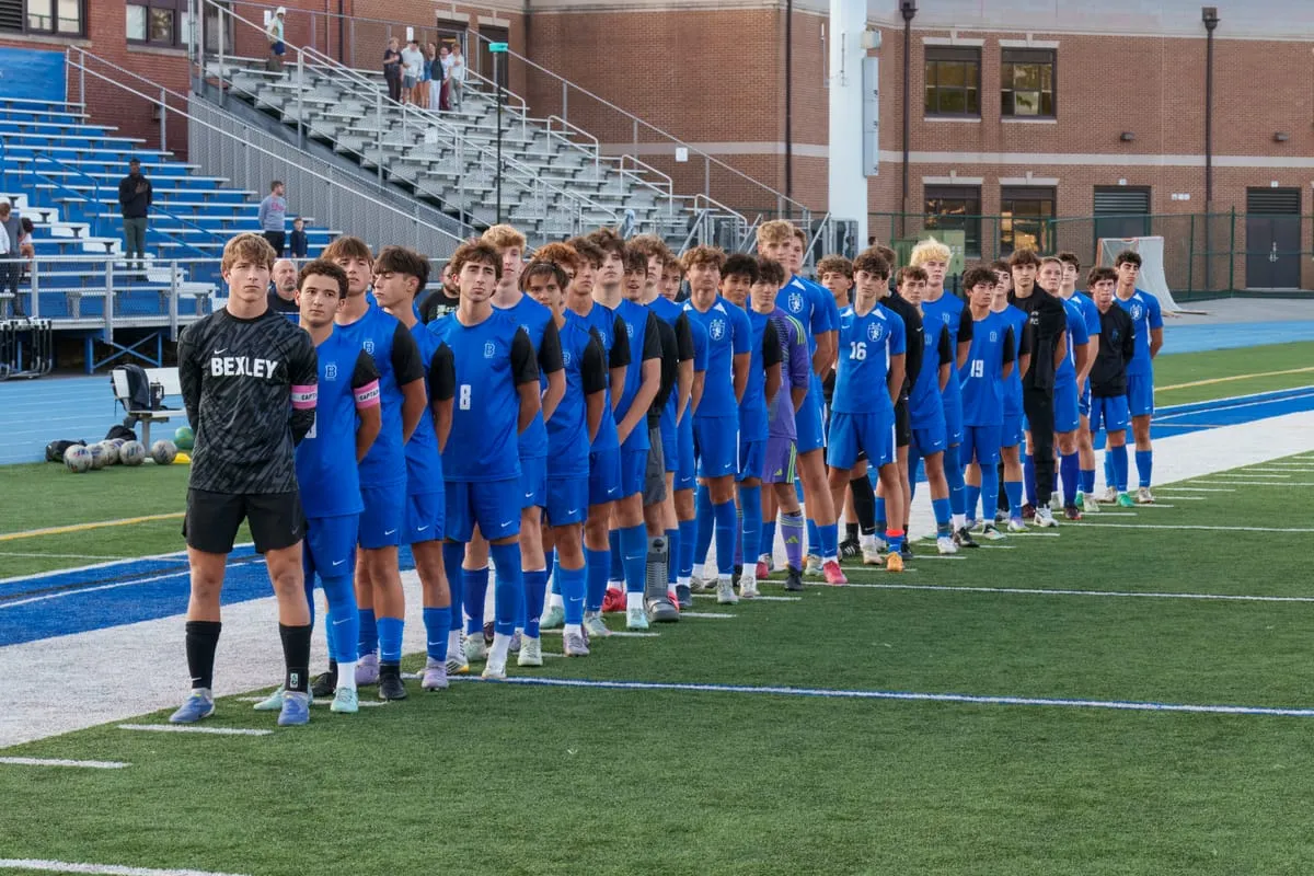 The Bexley soccer team lined up on a synthetic turf field