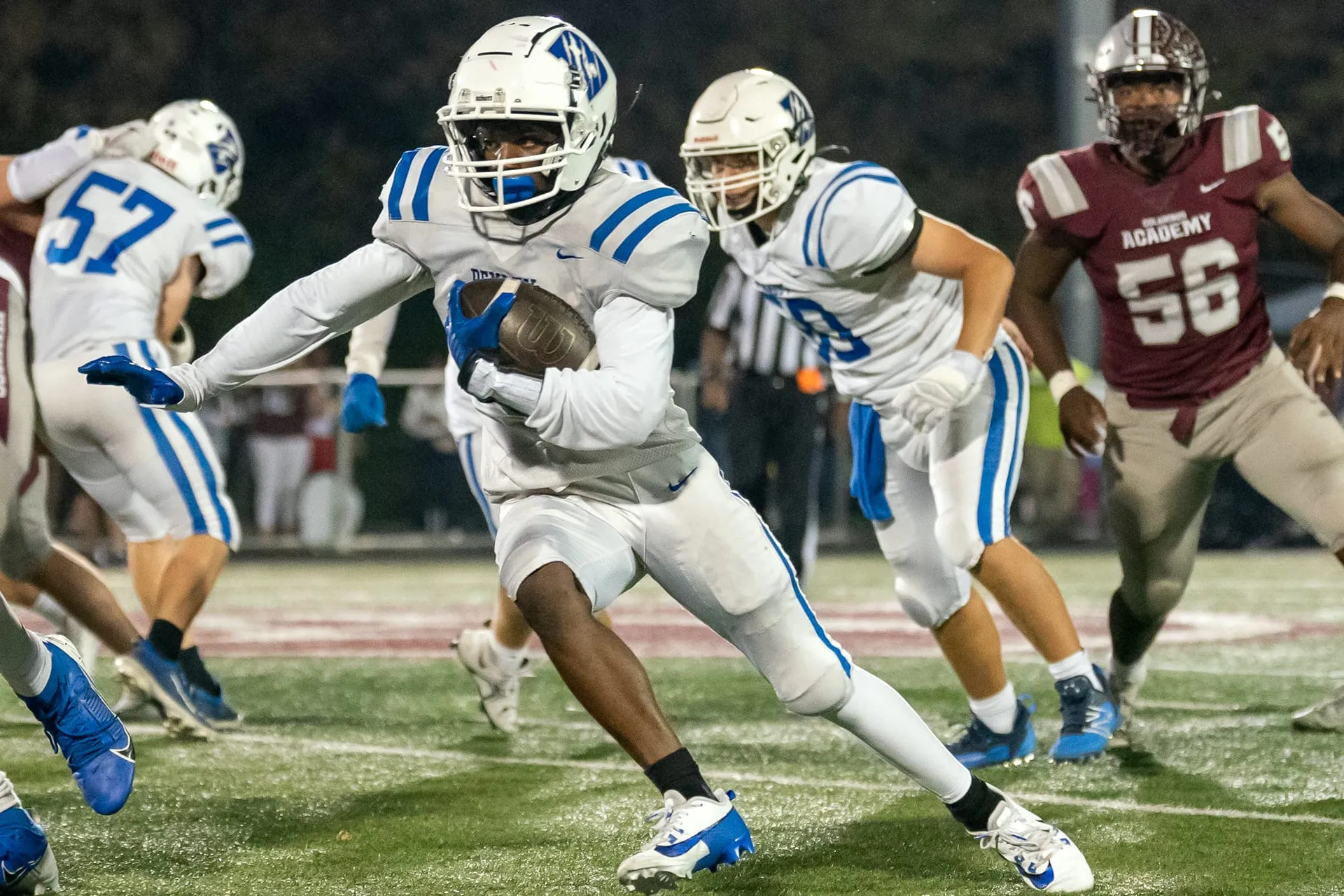 A Bexley ball carrier cutting back through traffic under the Friday night lights