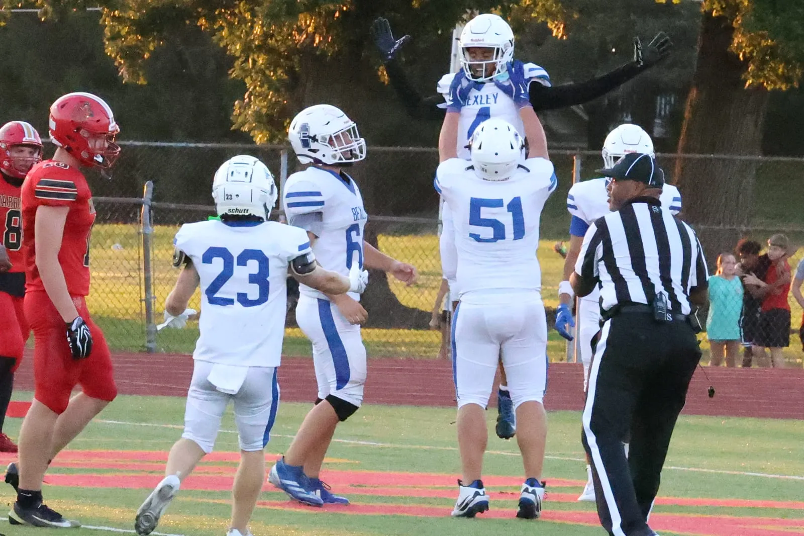 Bexley players celebrating in the end zone after a touchdown